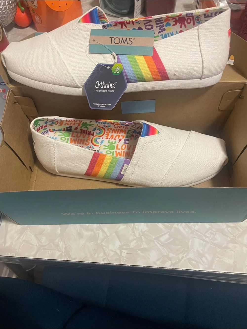 TOMS White Canvas Slip-Ons with Rainbow Stripes